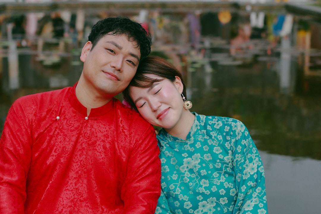 Couple in traditional clothing smiling together outdoors